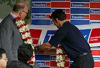 Adam Gilchrist cutting ribbon at the first Travelex Branch in Mumbai
