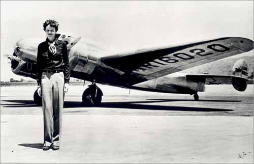 Amelia Earhart stands in front of the Lockheed Electra she was trying to fly around the world in 1937